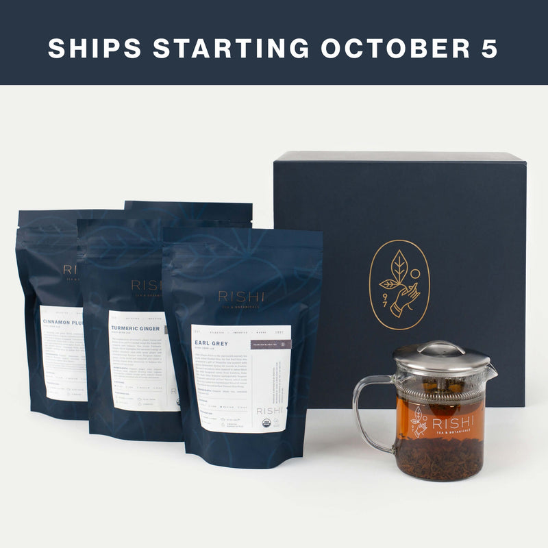 Three tea bags, a glass teapot with tea, and a dark tea gift box are displayed under a banner that reads “Ships Starting October 5.”.
