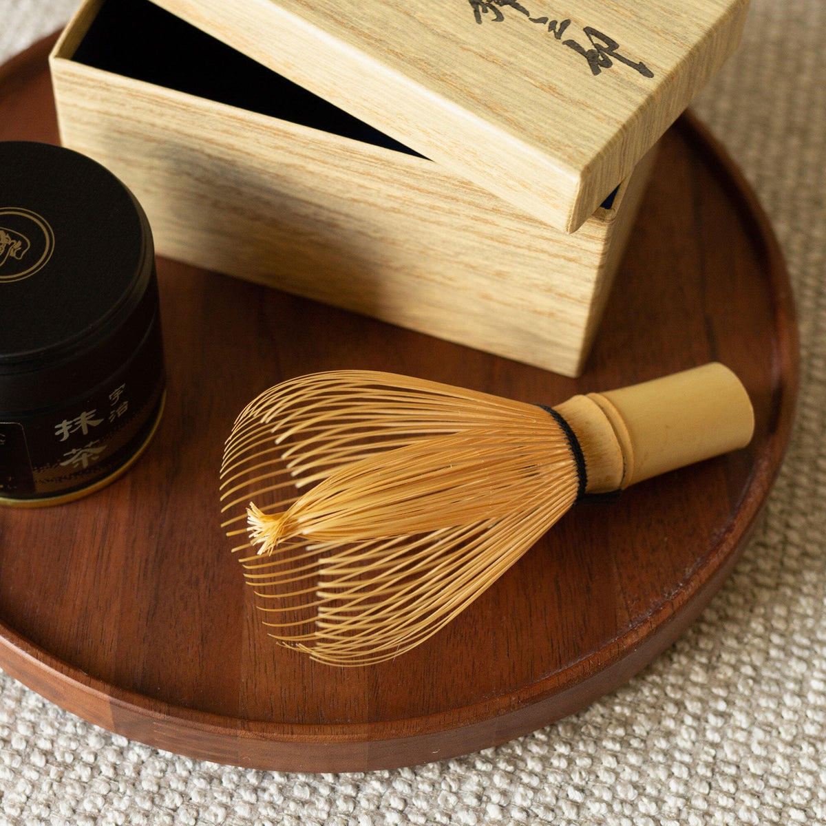 A premium Shin Chasen by Rishi Tea & Botanicals with a flexible wooden whisk and a breakage-resistant box next to it.