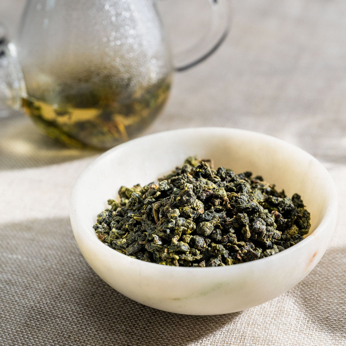 Four Seasons Spring green tea in a bowl on a table from Rishi Tea & Botanicals.
