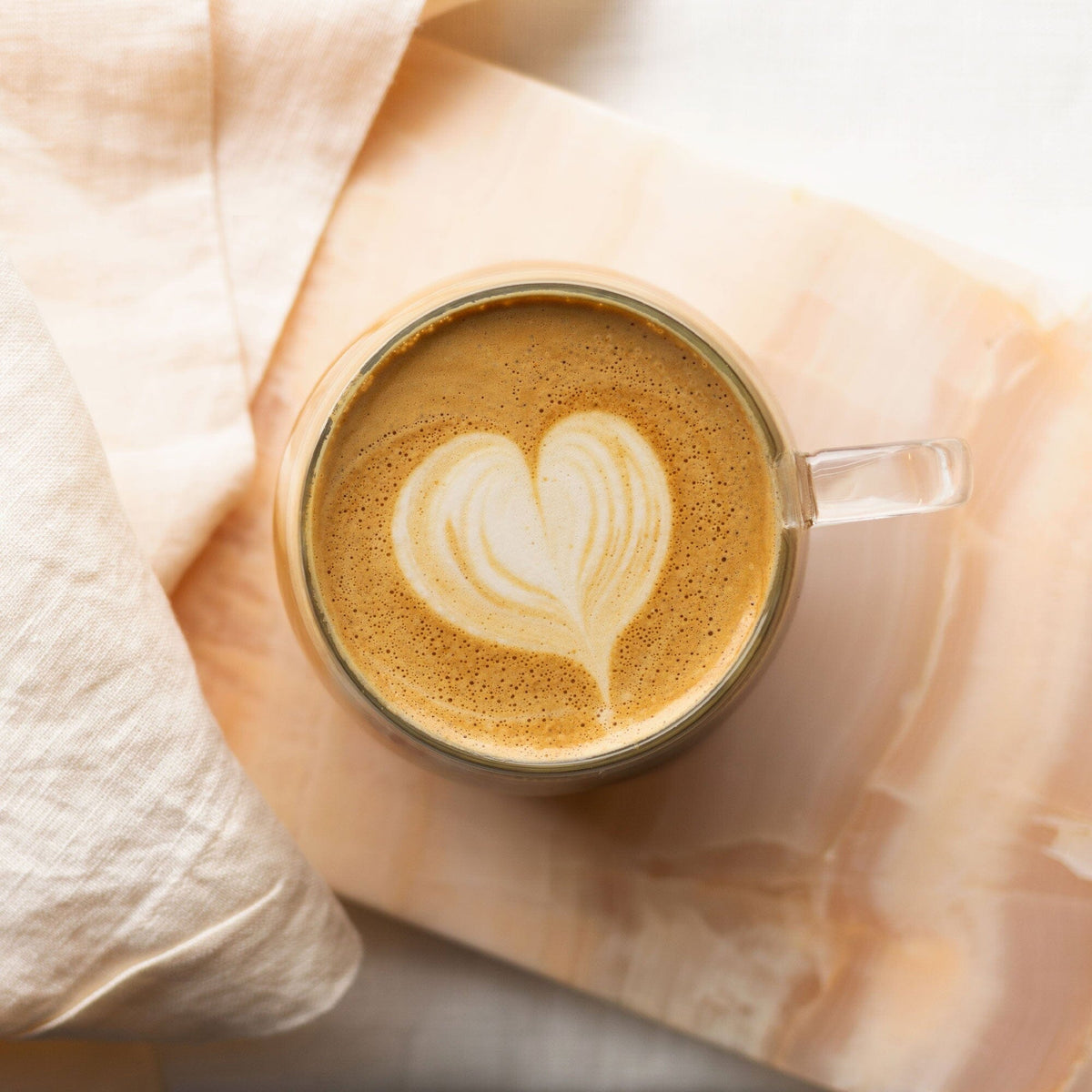 A cup of Rishi Tea & Botanicals Houjicha Powder with a heart shaped latte art.