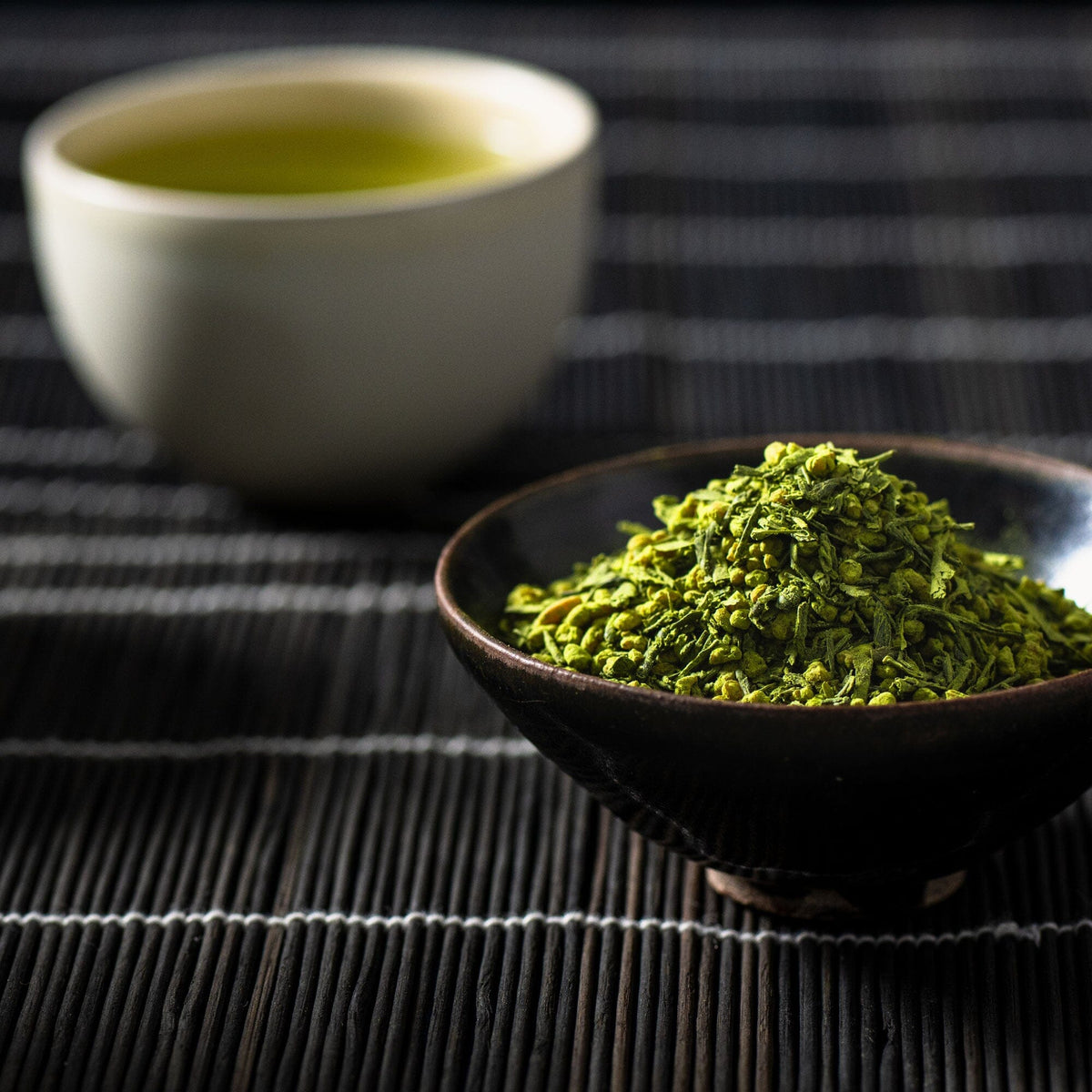A bowl of Matcha Genmaicha tea next to a cup. (Rishi Tea & Botanicals)