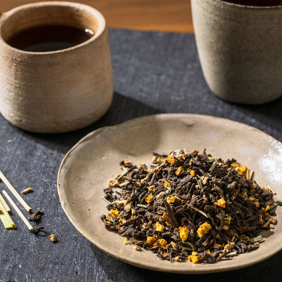 Pu'er Ginger tea from Rishi Tea & Botanicals in a bowl next to a cup of tea.