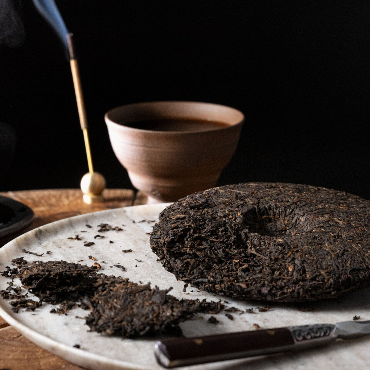 A piece of Rishi Tea & Botanicals Pu'er Tea Cake on a plate.