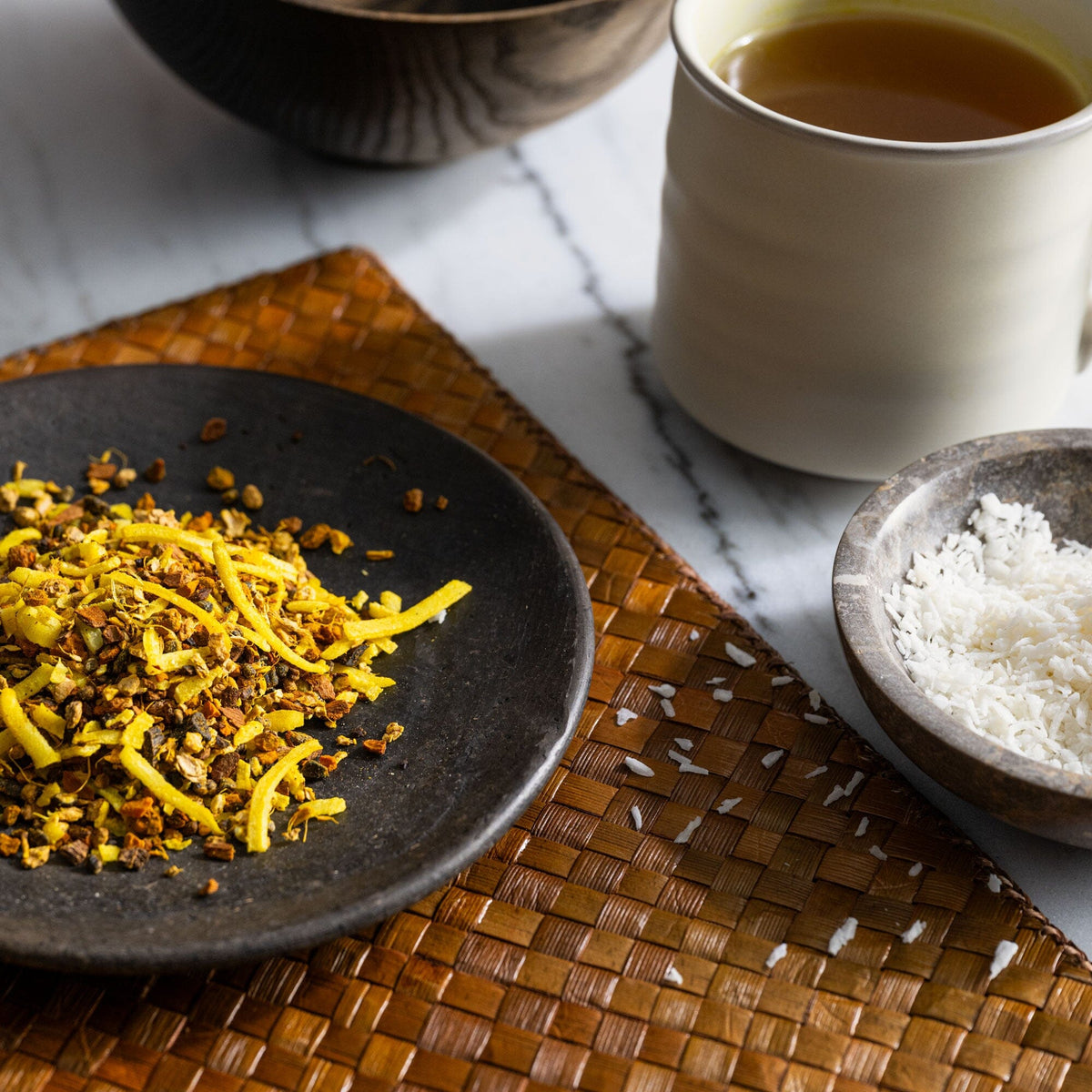 A plate with a cup of Turmeric Chai from Rishi Tea & Botanicals and a bowl of rice.