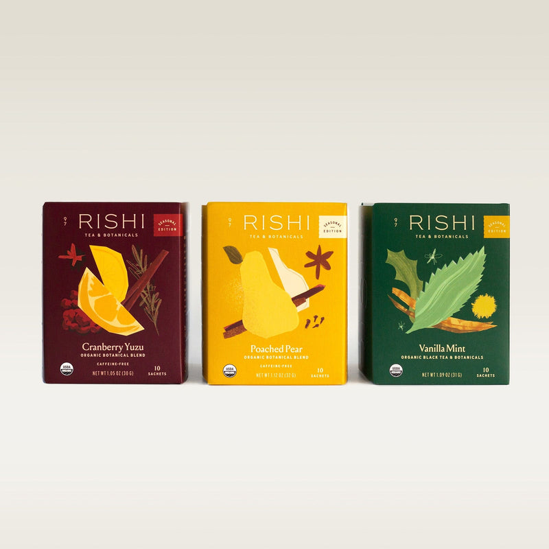 Three Rishi Tea & Botanicals boxes—Cranberry Yuzu, Poached Pear, and Vanilla Mint—are displayed side by side, highlighting a winter bundle of organic tea blends perfect for the season.