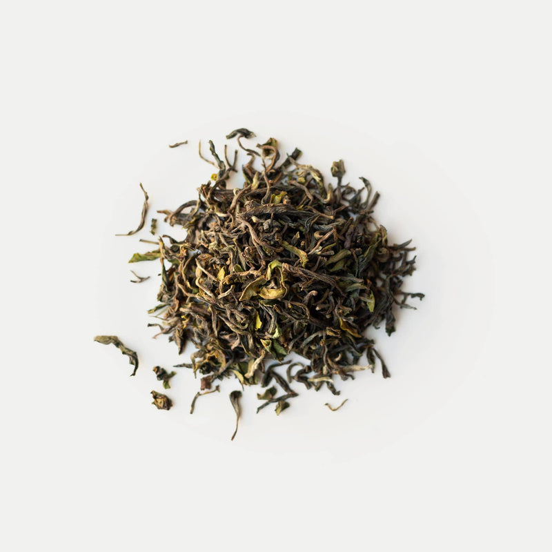 A pile of Darjeeling First Flush Lingia DJ4 from the Rishi Tea & Botanicals estate rests against a plain white background.