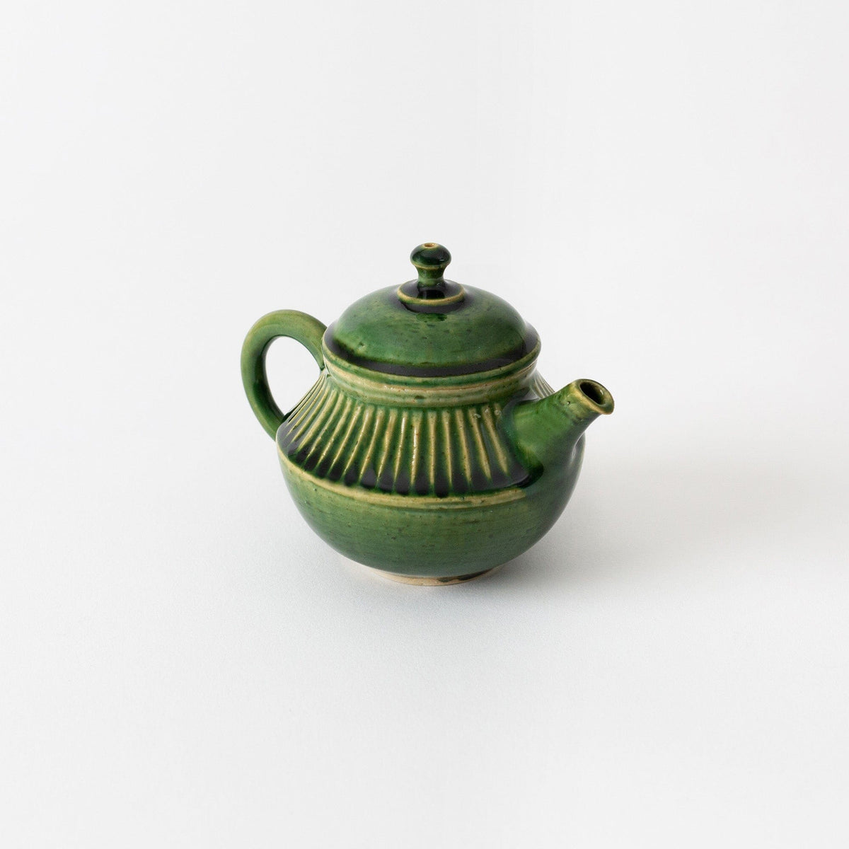 A small, green Rishi Tea & Botanicals Tokoname kyusu teapot with a single handle, spout, and ridged design on its body, displayed against a plain white background.